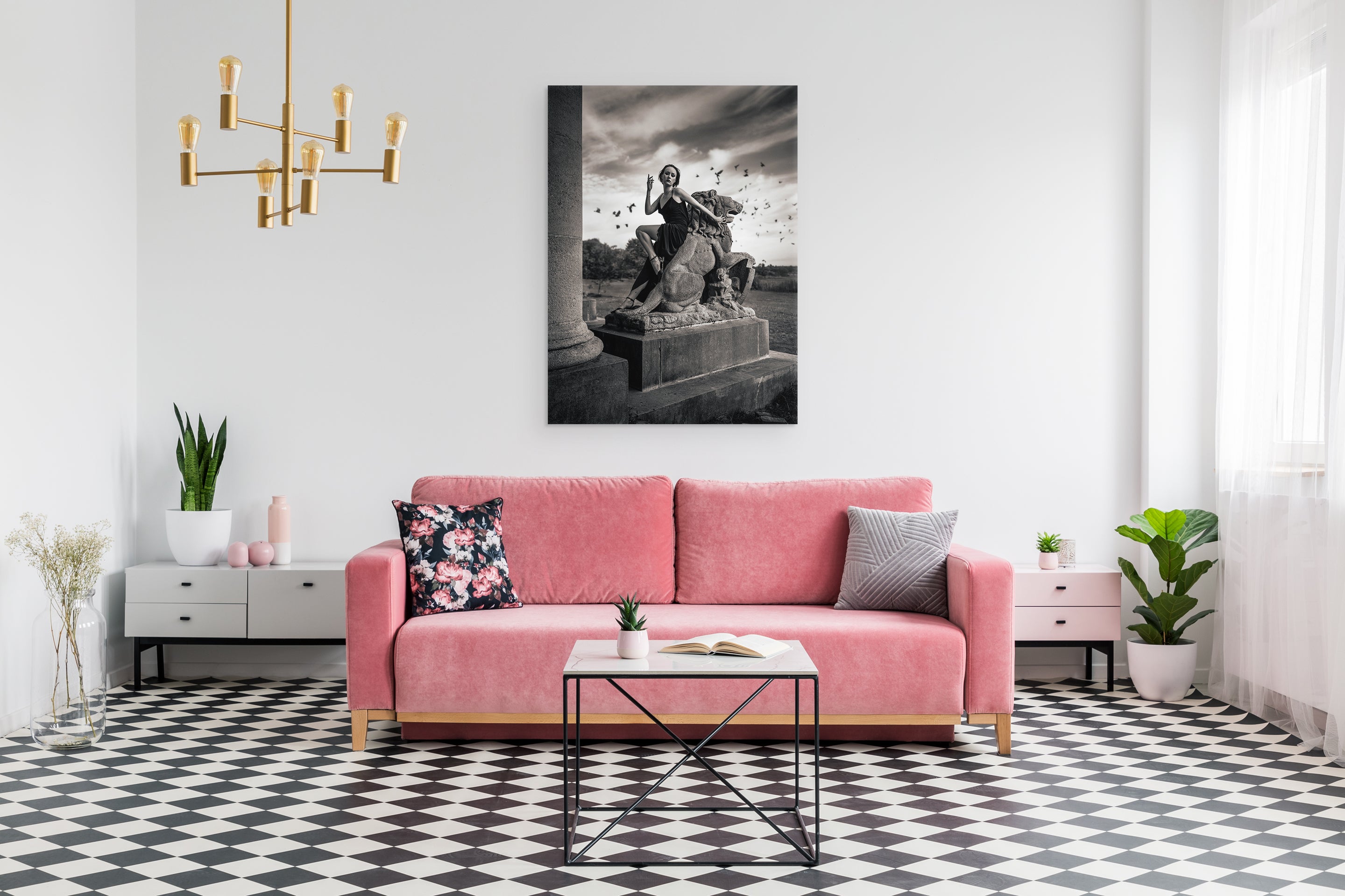 Living room with a pink sofa, coffee table, and decorative wall art.
