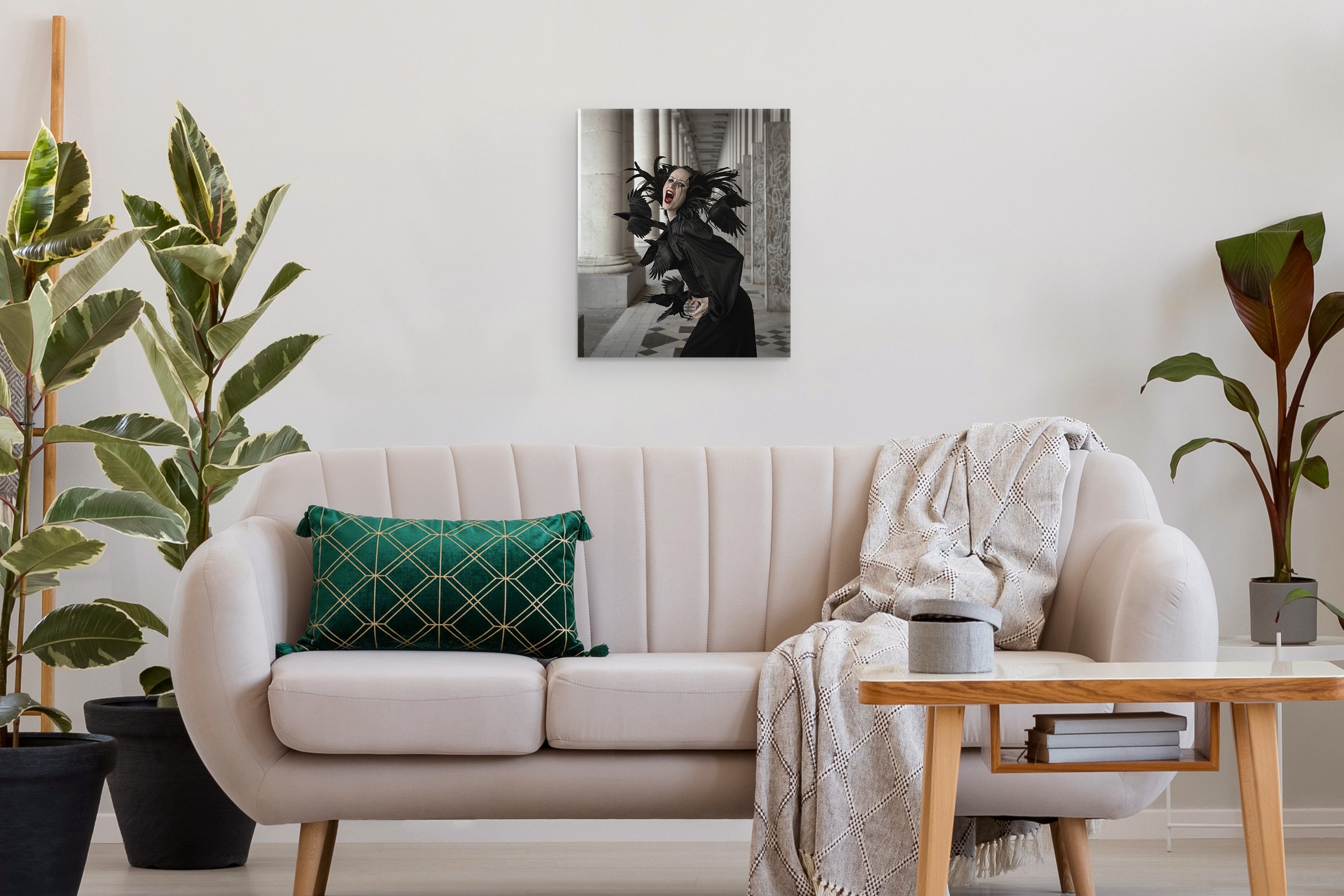 Living room with a beige sofa, green pillow, and a small table with decor items.