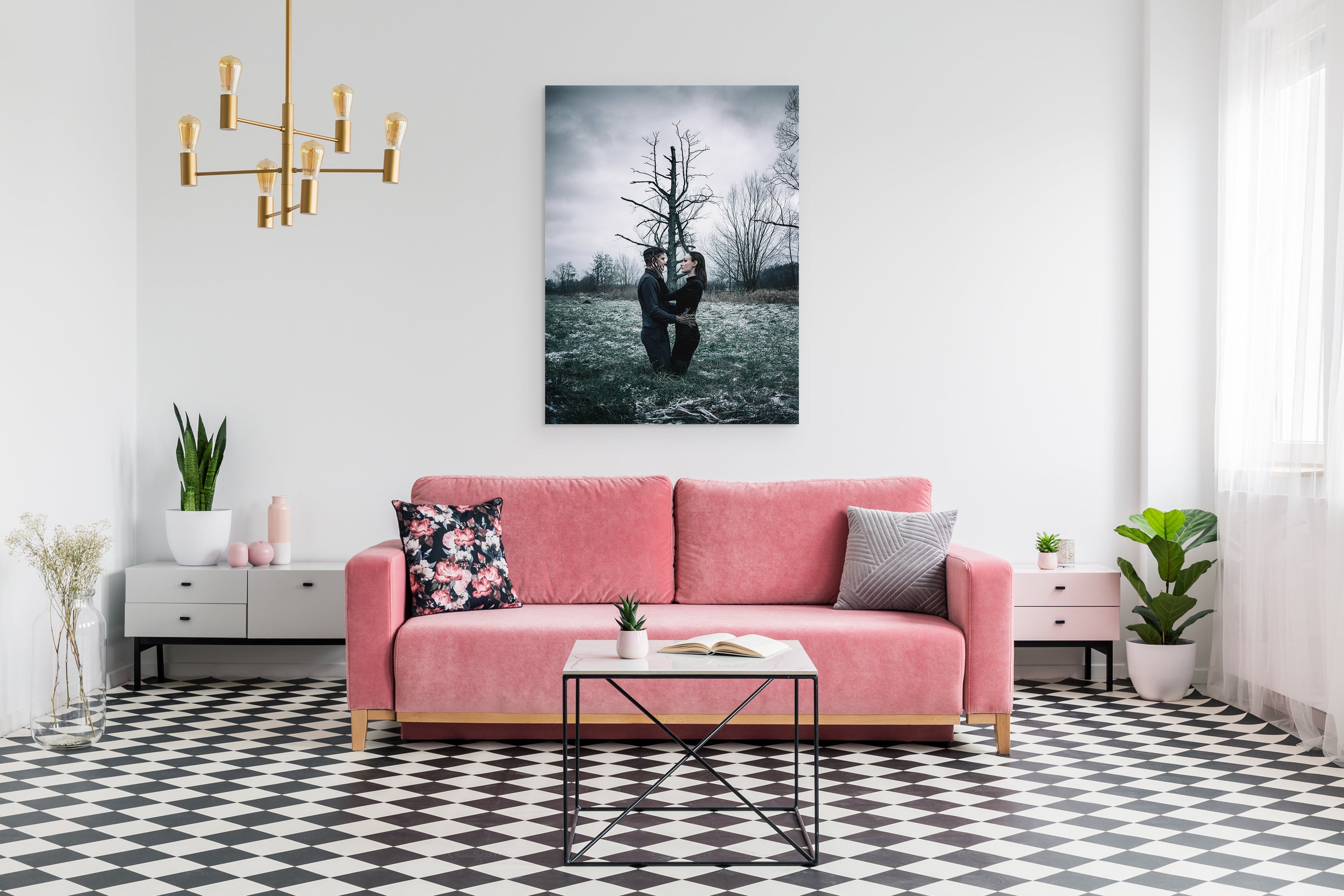 Living room with a pink sofa, coffee table, and decorative wall art.