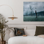 Living room with a sofa, decorative pillows, a plant, and a wall art piece.