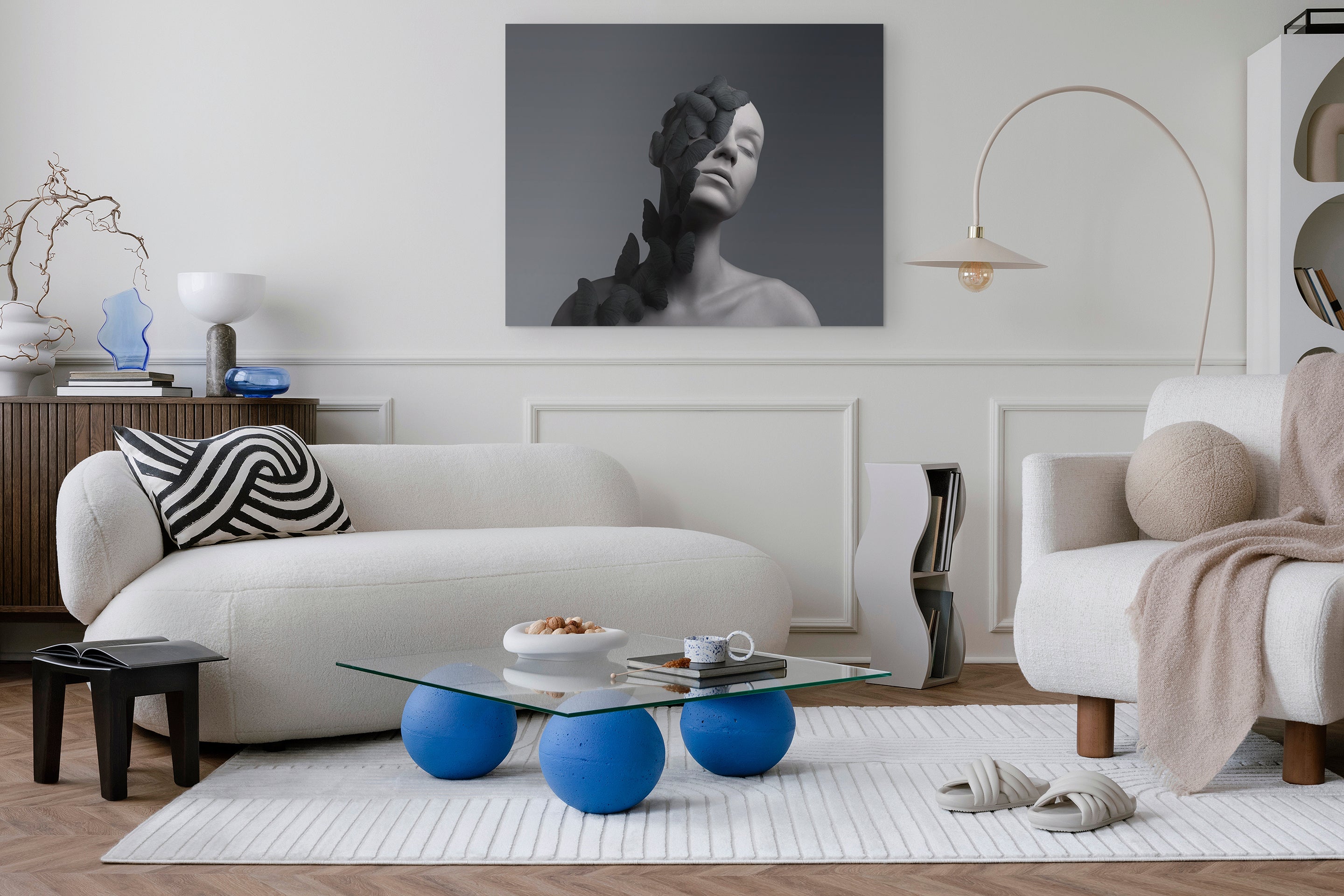 Modern living room with white sofa, blue coffee table, and decorative elements.